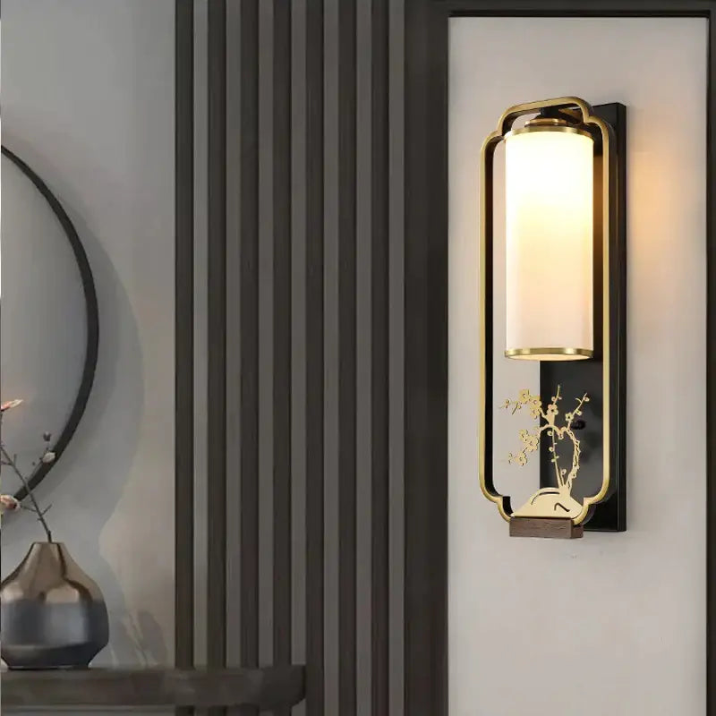 Gold-toned iron glass wall lamp with frosted glass cylinder and carved bamboo motif for bedroom or living room decorbites iron glass wall