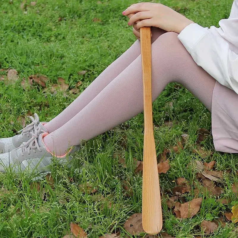 Light brown wooden shoe brush with polished finish and curved handle for bamboo pattern long handle shoe lifter use