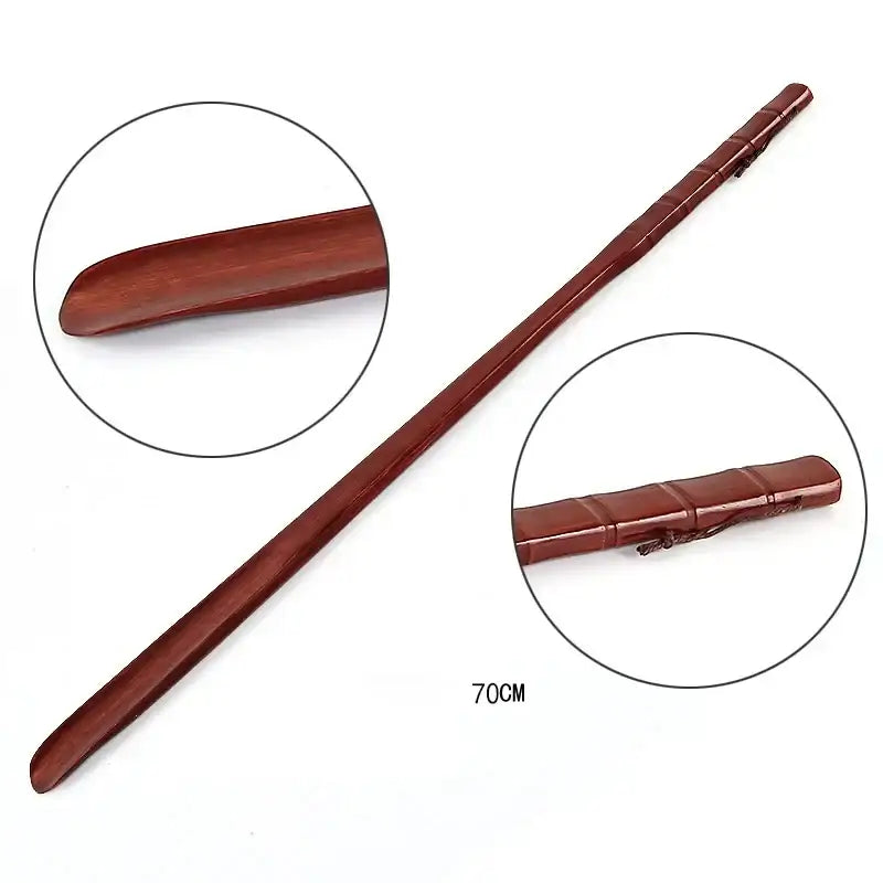 A long handle reddish-brown wooden shoe lifter with bamboo pattern and smooth curved handle for bedroom dressing aid