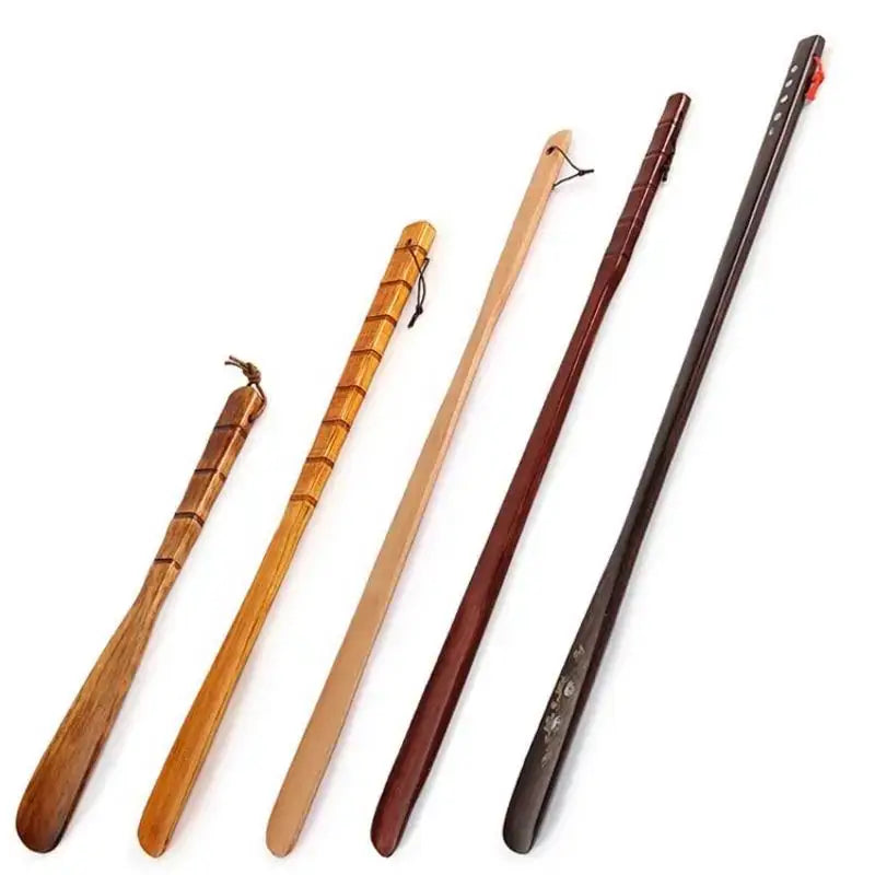 Set of five wooden shoe shapers with bamboo pattern long handle shoe lifter design in natural and stained finishes