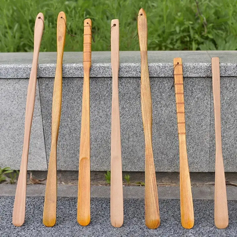 Set of seven natural wood long handle shoe lifters with bamboo pattern and grooved handles for bedroom dressing aid
