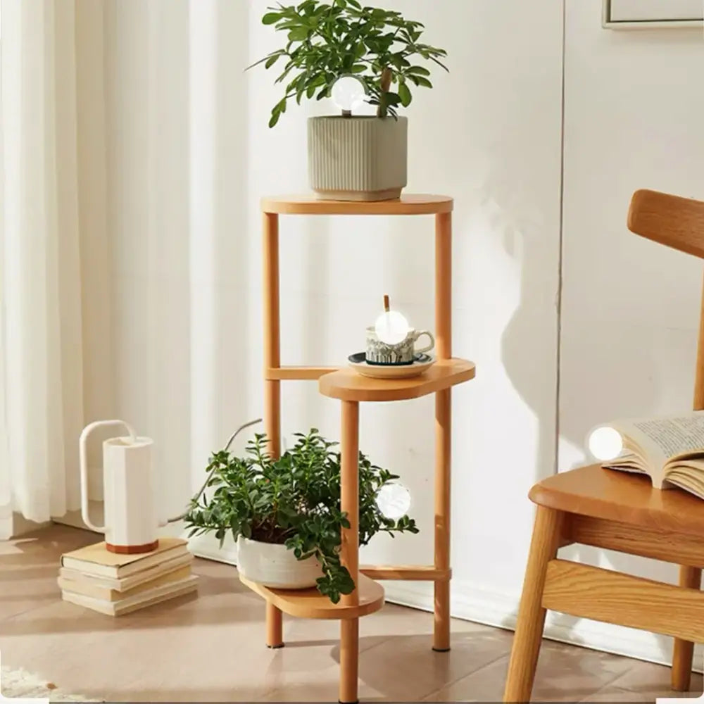 Light-colored bamboo corner plant stand with three circular shelves for flower display by DecorBites™