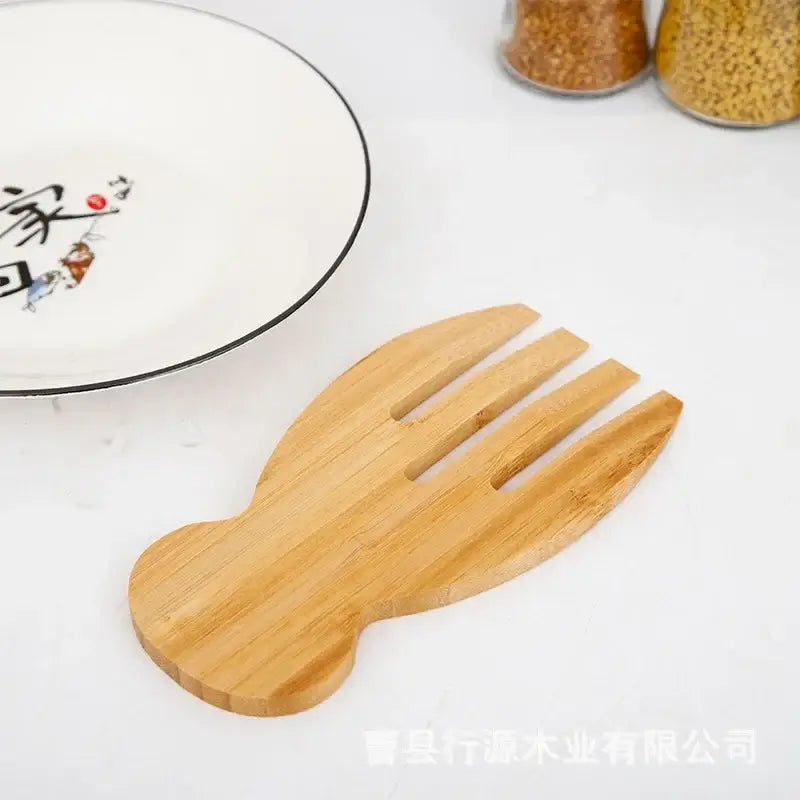 Light brown bamboo salad hands utensil shaped like a hand with four fingers from decorbites spoon set