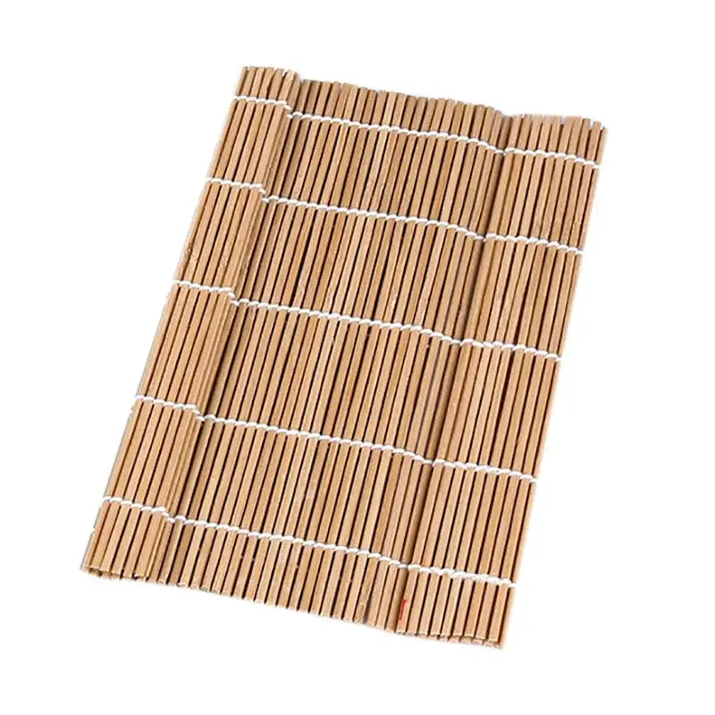 Light brown bamboo sushi rolling mat with white string bindings for sushi rolling and onigiri rice paddles use