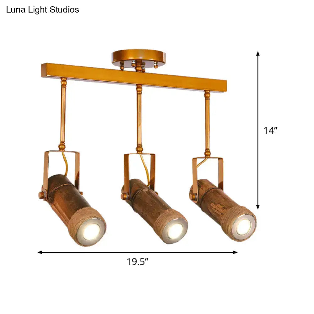 Gold-toned industrial ceiling fixture with three bamboo tube spotlight heads and hemp rope suspension for led light use