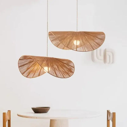 Two warm-toned bamboo wabi sabi pendant lights with fan-like woven rattan design for dining room lighting