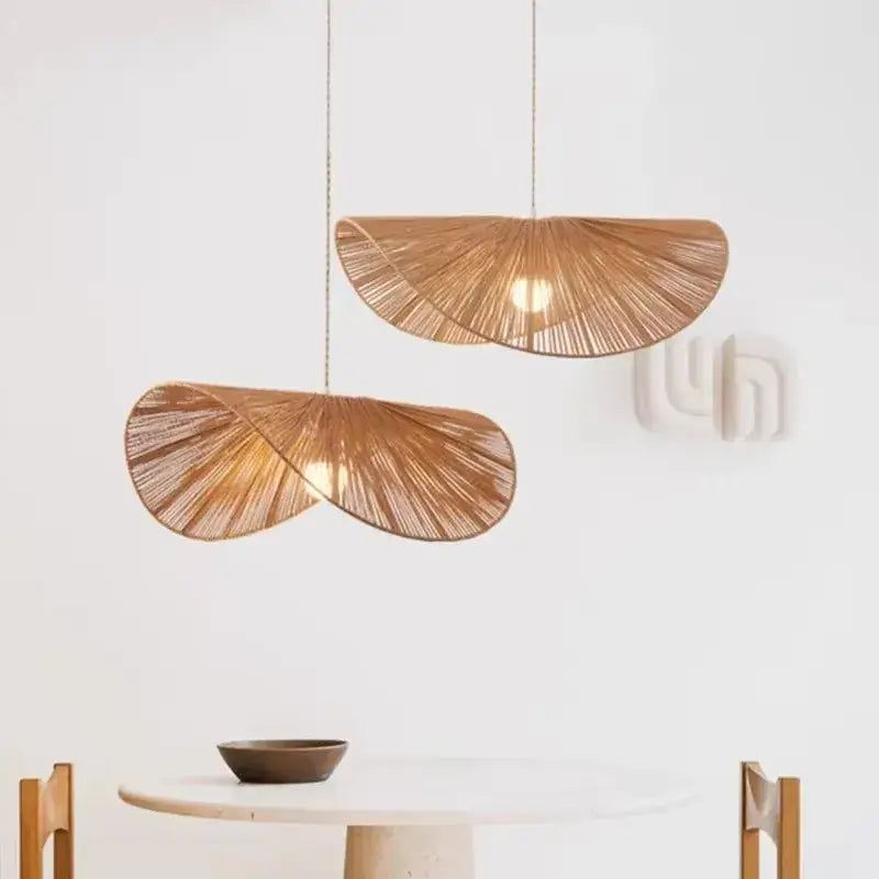 Two warm-toned bamboo wabi sabi pendant lights with fan-like woven rattan design for dining room lighting