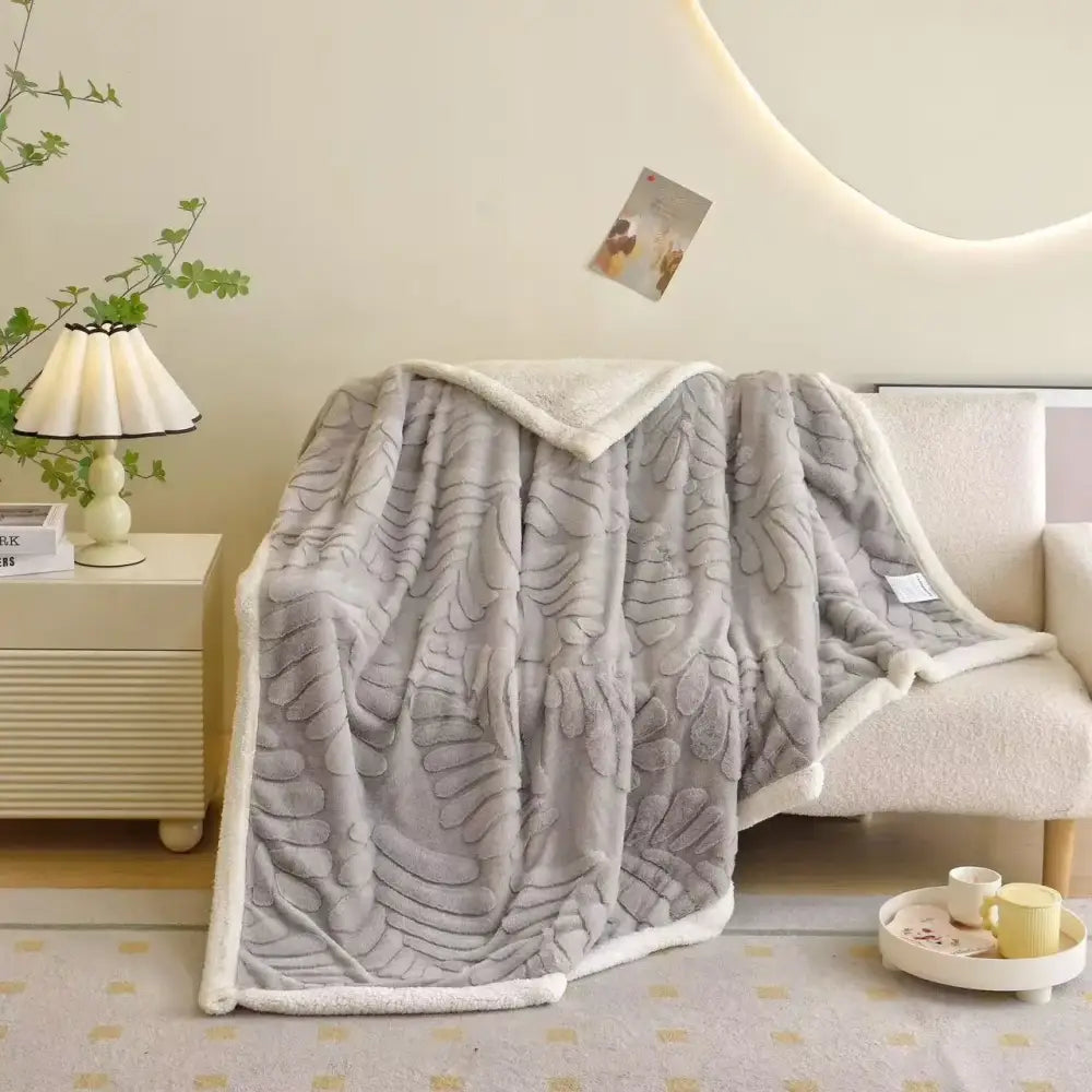 Gray banana leaf jacquard faux rabbit fur throw blanket with soft textured leaf jacquard and white fleece lining