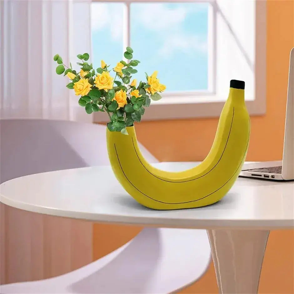 Yellow banana shape resin flower vase with black tip and subtle line detailing made of ceramic material