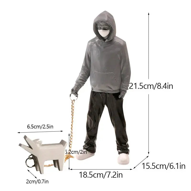 Gray hooded figure banksy dog walker resin statue holding gold chain leash with white minimalist dog keychain black and white
