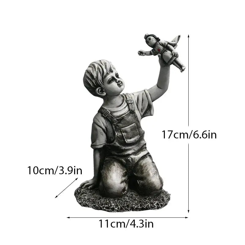 Detailed gray resin banksy sculpture collection figurine of a kneeling boy in overalls holding a doll for living room decor