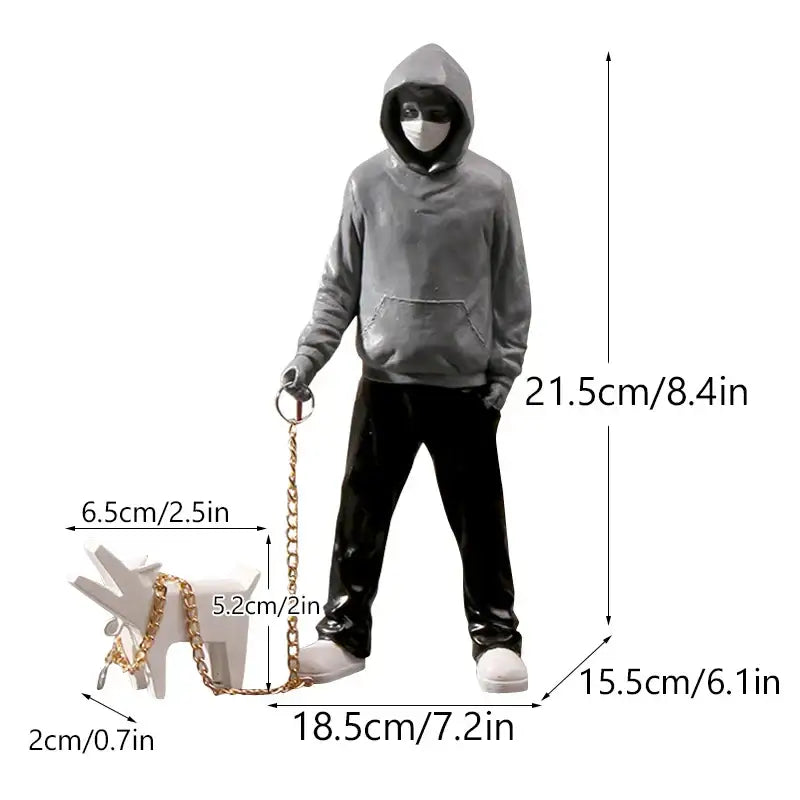 Gray hooded figure figurine holding gold chain leash attached to white dog in banksy sculpture collection decor