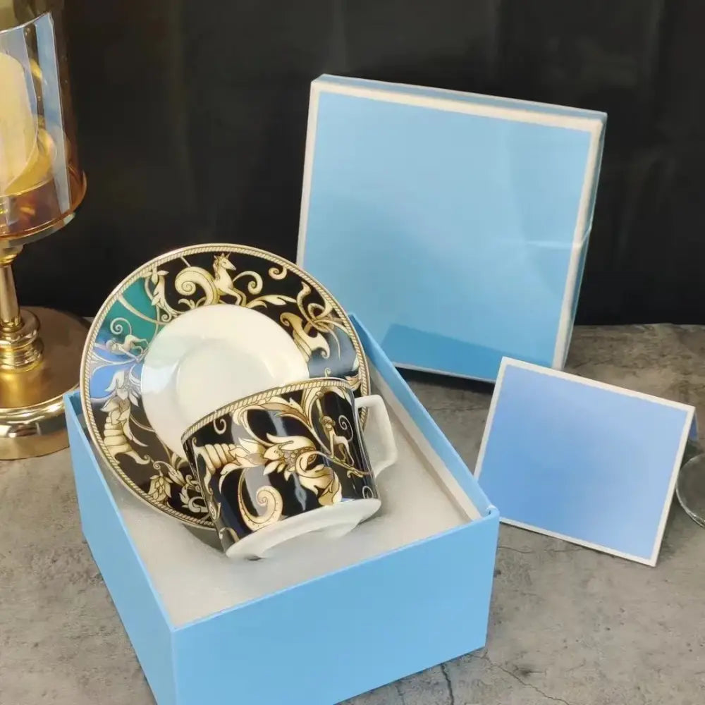 Elegant black and gold porcelain espresso cup with baroque detailing in a light blue box from black unicorn series kitchenware
