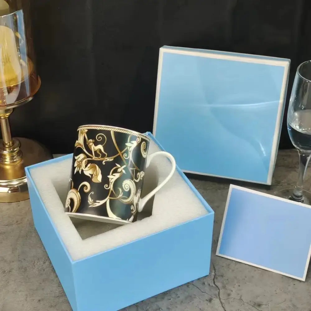 Elegant black ceramic mug with gold filigree in light blue gift box from black unicorn series kitchenware