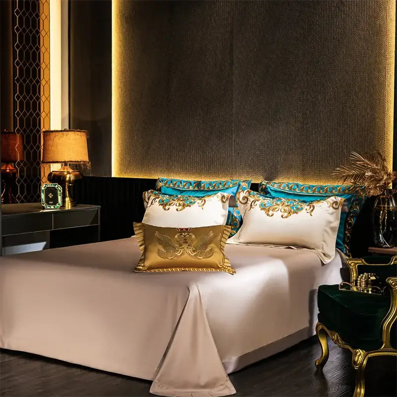 Luxurious cream satin bedding set with gold embroidered pillows and teal accents in baroque blue and gold cotton bedding