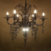 Ornate black wrought iron decorbites baroque designer hanging chandelier with intricate arms and geometric crystal pendants