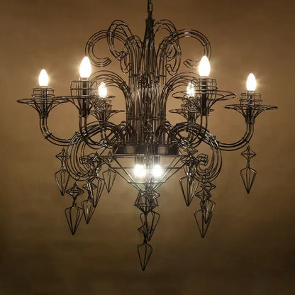 Ornate black wrought iron baroque designer led chandelier with swirling arms and geometric crystal pendants for dining room
