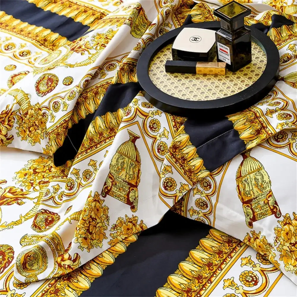 A luxurious white and gold Versace print silk scarf with intricate baroque patterns complements decorbites 1200tc golden bedding set