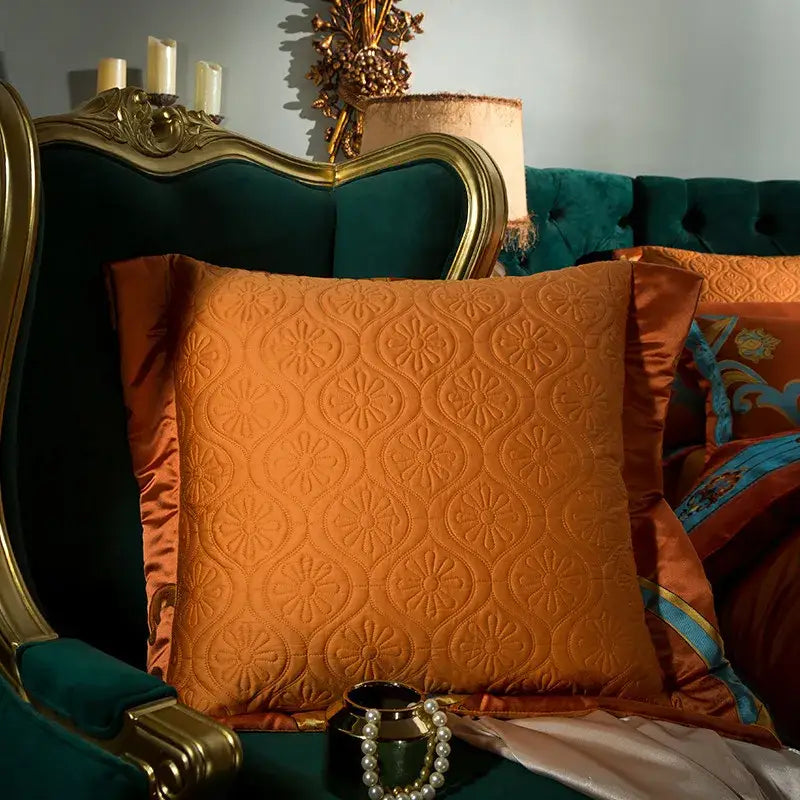Orangish-brown quilted pillow with floral pattern and satin trim from baroque orchid gold 200s embroidery cotton bedding set
