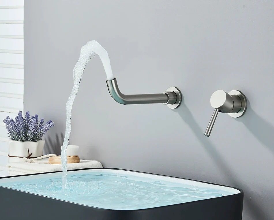 Modern brushed nickel wall-mounted basin faucet with curved spout and hot water control flowing into black sink