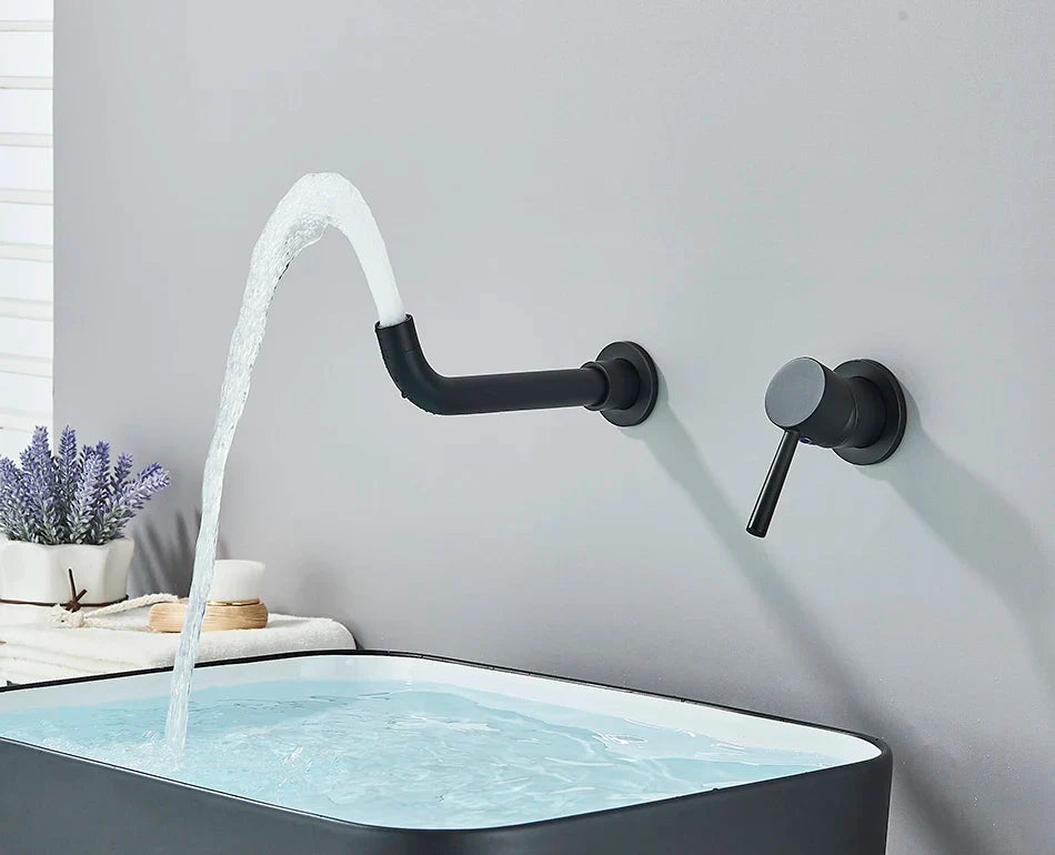 Black matte-finish wall-mounted basin faucet with curved spout and hot water control flowing into matching sink