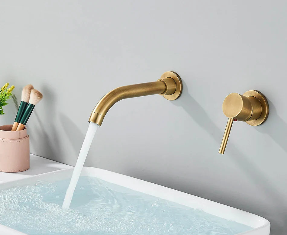 Gold-toned basin faucet wall mounted bathroom fixture with brushed brass finish and hot water control curved spout
