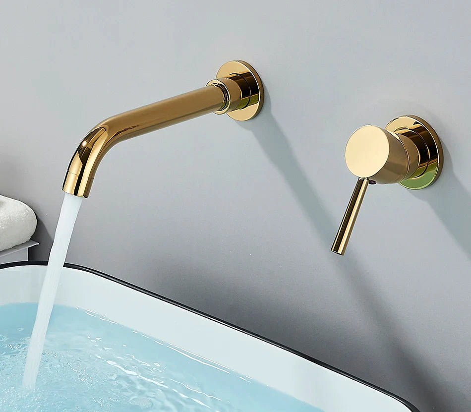 Gold-toned basin faucet wall mounted bathroom fixture with brushed brass finish and hot water control circular handle