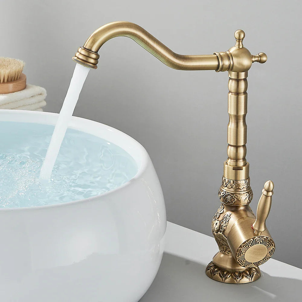 Antique brass single handle bathroom basin faucet with ornate vintage detailing and curved spout for single hole installation