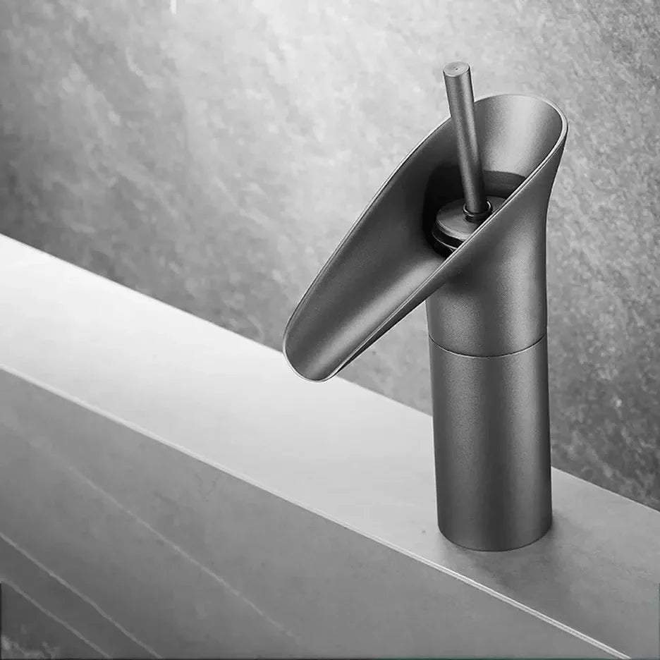 Modern matte black deck mounted bathroom faucet with sleek curved spout and metered valve control for efficient use