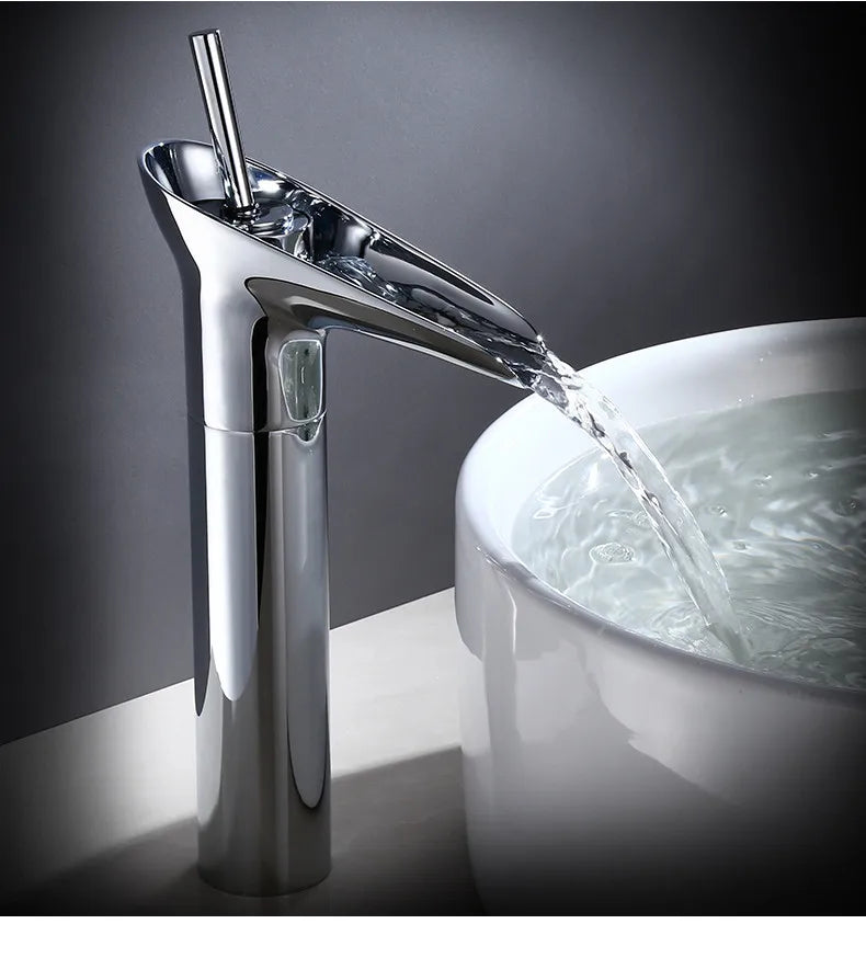 Bathroom faucet antique brass waterfall deck mounted with chrome finished waterfall spout and metered valve control flowing water into white ceramic sink