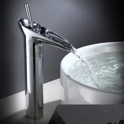 Chrome-finished deck mounted bathroom faucet with sleek waterfall design and metered valve control for modern use
