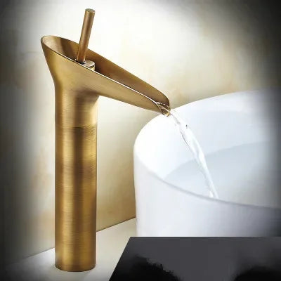 Gold-toned brushed metal bathroom faucet antique brass waterfall with deck mounted metered valve control and sleek design
