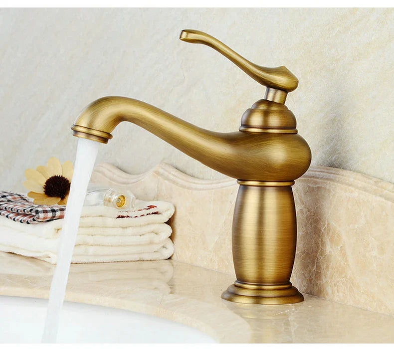 Antique brass-finished bathroom faucet with single handle and curved spout featuring vintage bronze finish design