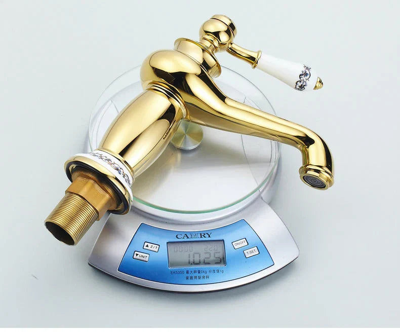 Bathroom faucet bronze finish with gold-finished brass body and white ceramic handle featuring black floral detailing
