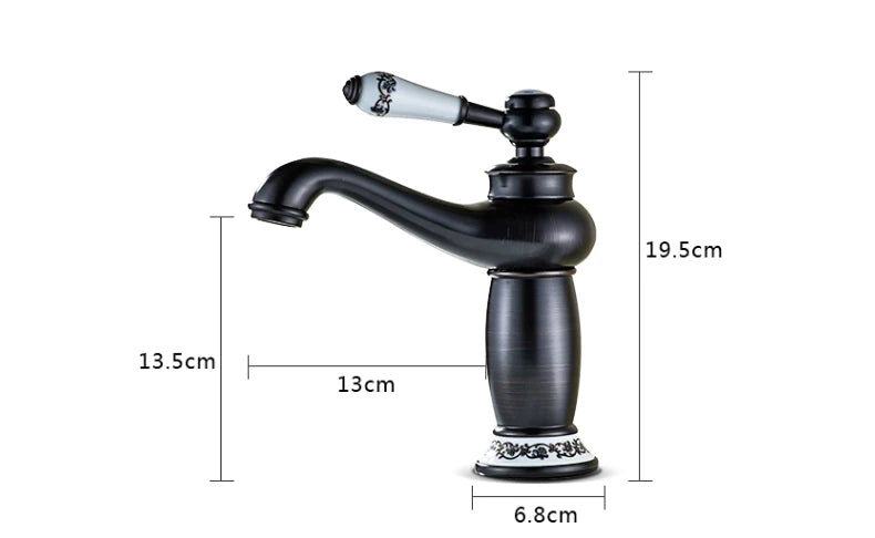 Black matte bathroom faucet with bronze finish featuring a white ceramic handle with black floral detailing and ornate base accents
