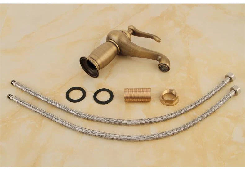 Antique brass single-handle bathroom faucet with bronze finish flexible metal hoses and mounting hardware visible