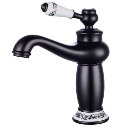 Black matte bathroom faucet with white ceramic handle and base featuring black patterns in antique bronze finish