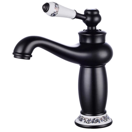 Black matte bathroom faucet with white ceramic handle and base featuring black patterns in antique bronze finish