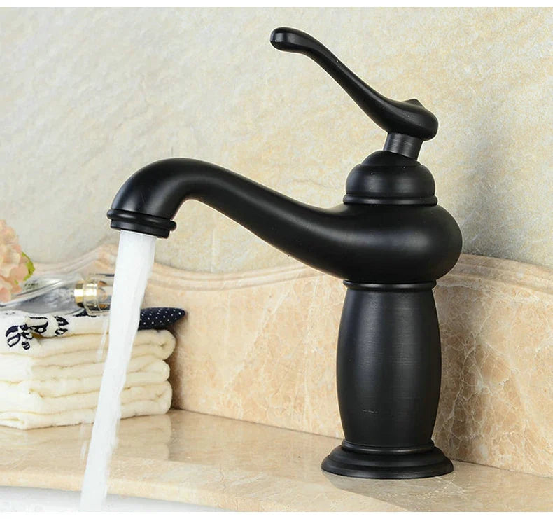 Black matte single-handle bathroom faucet with curved spout and elegant design in antique bronze finish