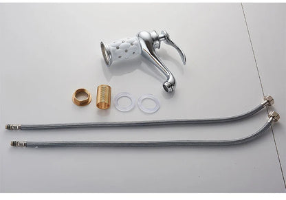 Chrome-finished kitchen faucet with white perforated spray head and flexible metal hoses in bronze finish detail