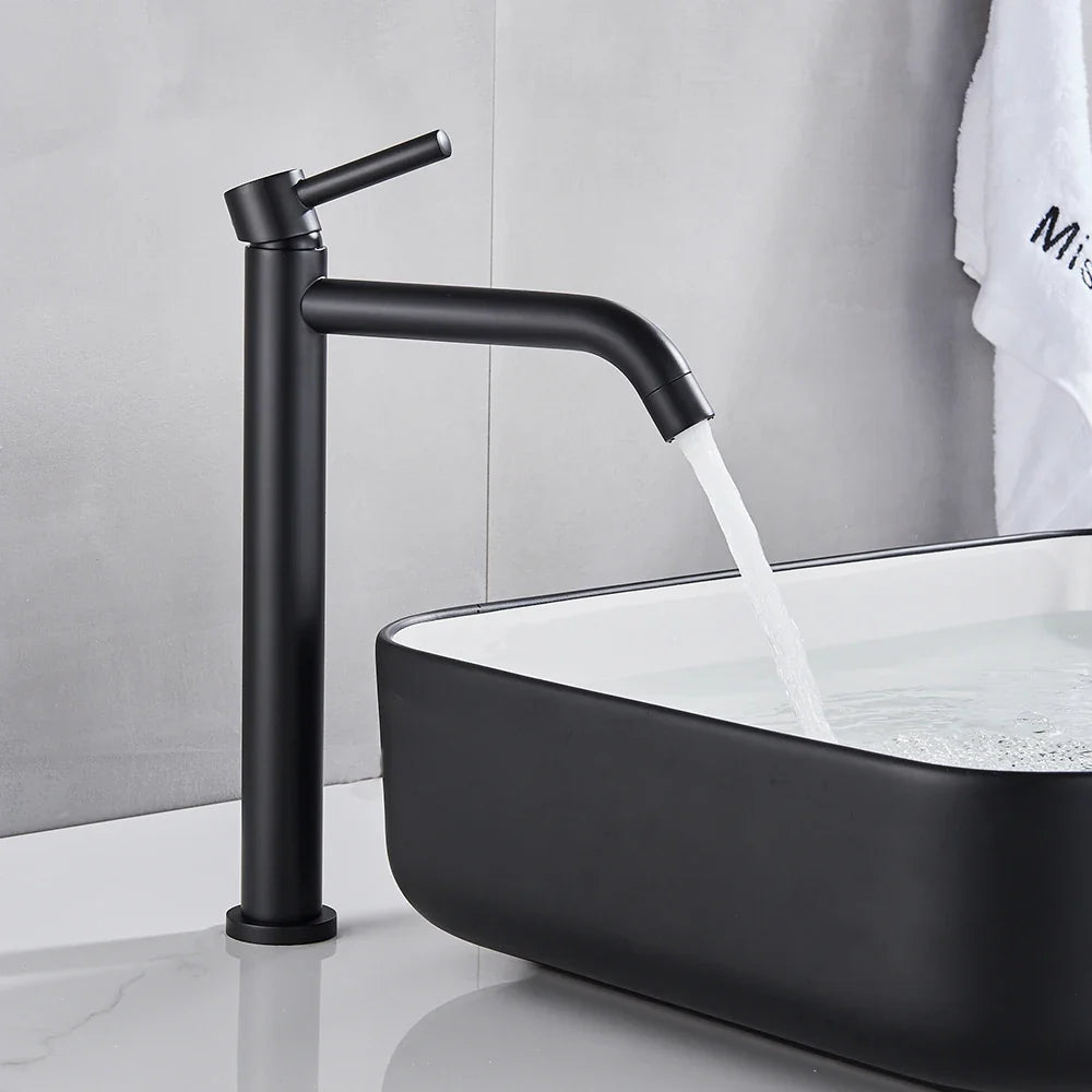 Black matte-finish modern bathroom faucet with tall slender spout and handle designed as a brushed gold mixer tap