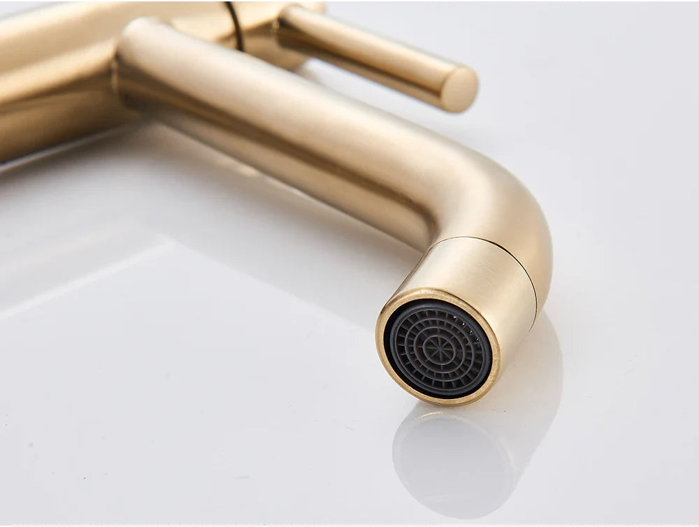Bathroom faucet brushed gold mixer tap with gold-toned finish, sleek curved spout, and black mesh spray head