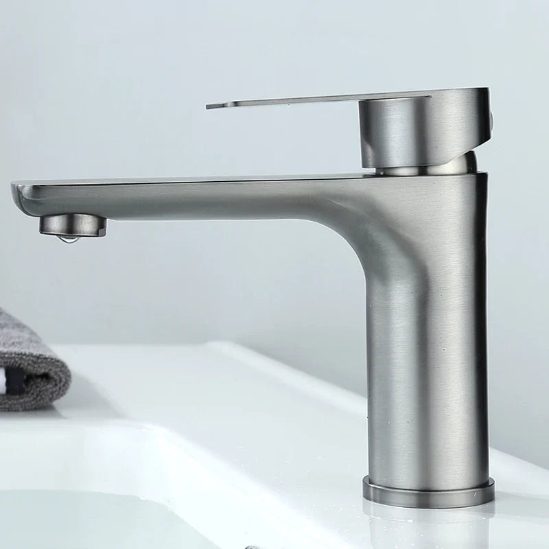 Modern brushed stainless steel single-handle bathroom faucet with deck-mounted installation and minimalist design
