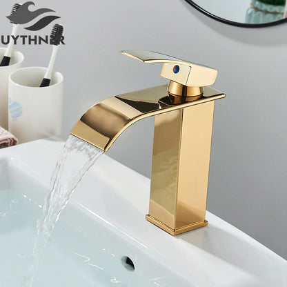 Gold-colored bathroom sink faucet brass deck mount with modern waterfall design and blue accent handle stainless steel material