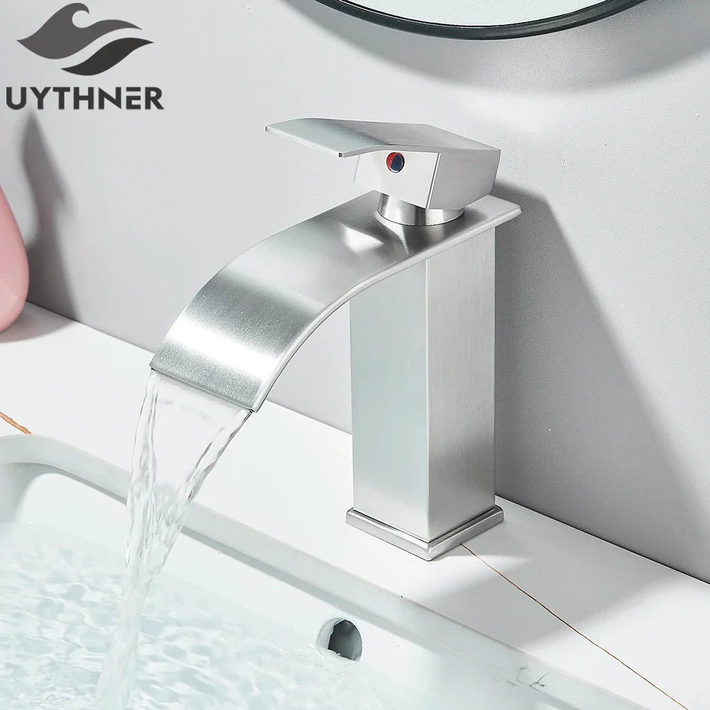 Modern brushed stainless steel bathroom sink faucet with waterfall design and red indicator dot on handle deck mount