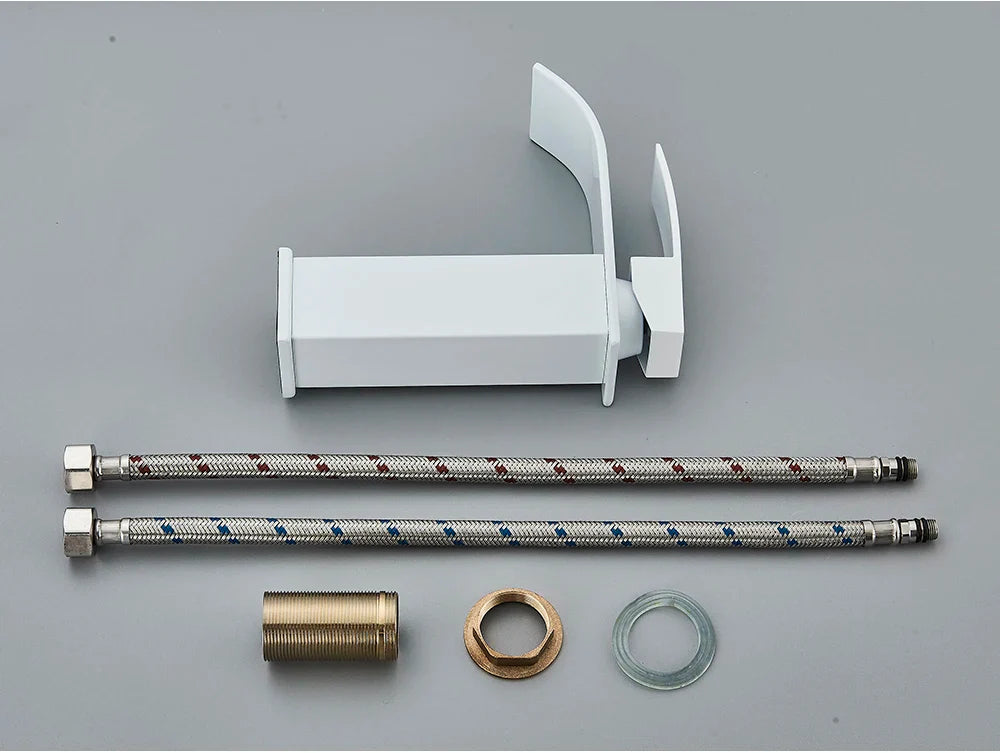 White plastic bathroom sink faucet with brass deck mount, stainless steel braided hoses, and brass fittings visible from back side