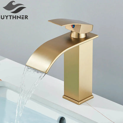Gold-colored bathroom sink faucet brass deck mount with brushed metallic finish stainless steel modern waterfall design