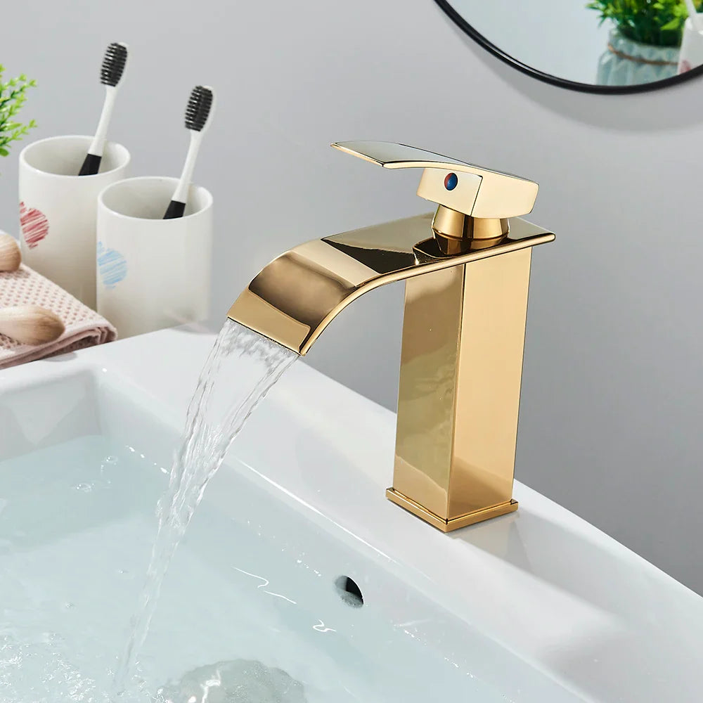 Gold-toned bathroom sink faucet brass deck mount with sleek rectangular design and stainless steel flowing spout