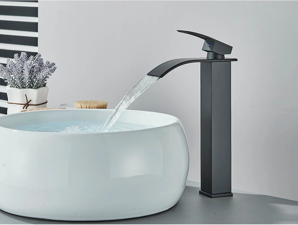 Black matte-finish bathroom sink faucet with brass deck mount and stainless steel waterfall design for modern use