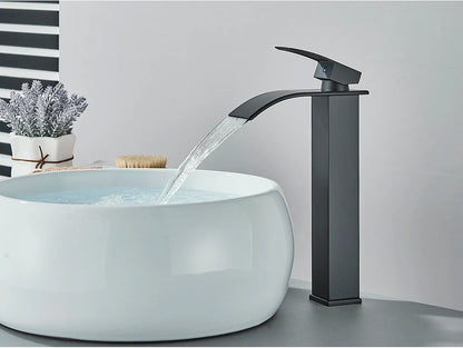 Black matte-finish bathroom sink faucet with brass deck mount and stainless steel waterfall design for modern use